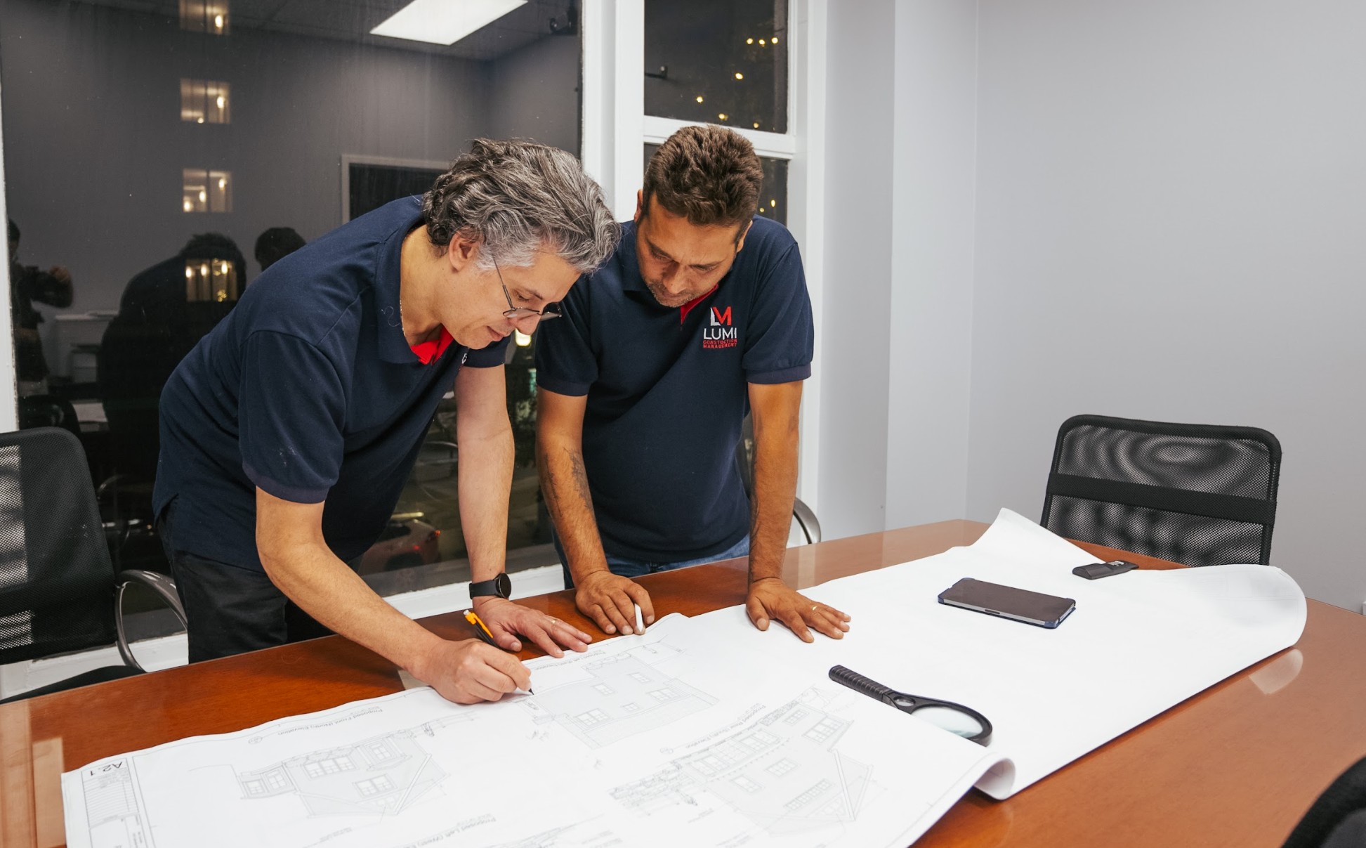Lumi Construction team reviewing blueprints